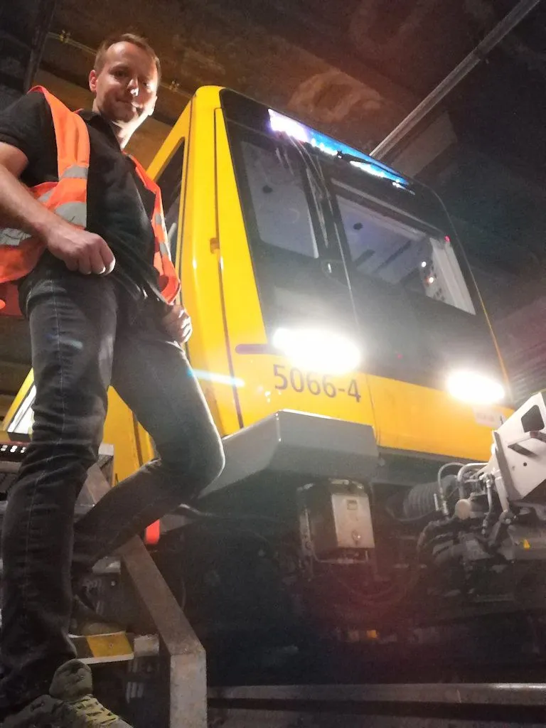 Working as a Berlin subway driver beside a train in the underground depot